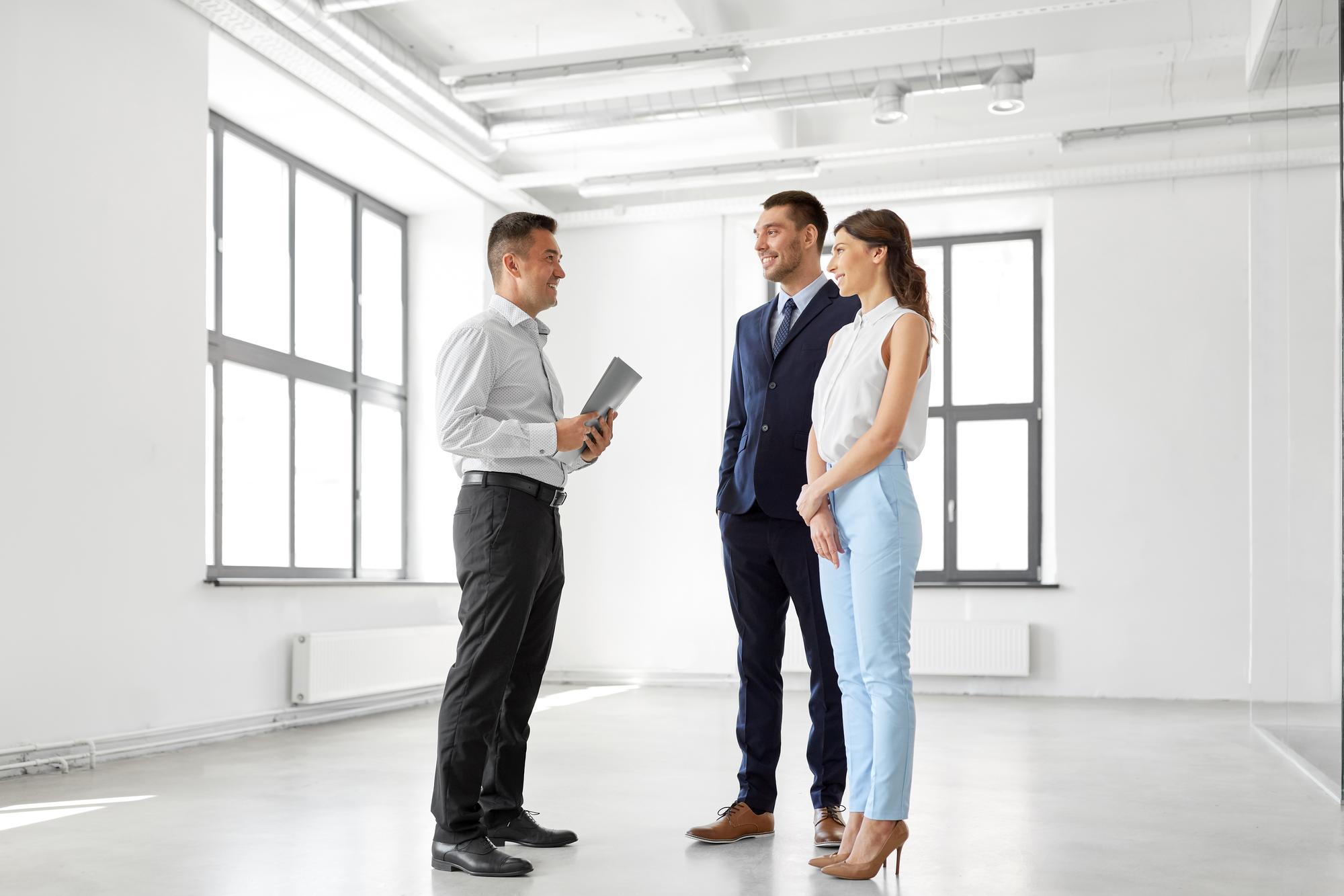 Agent showing an apartment interior to clients